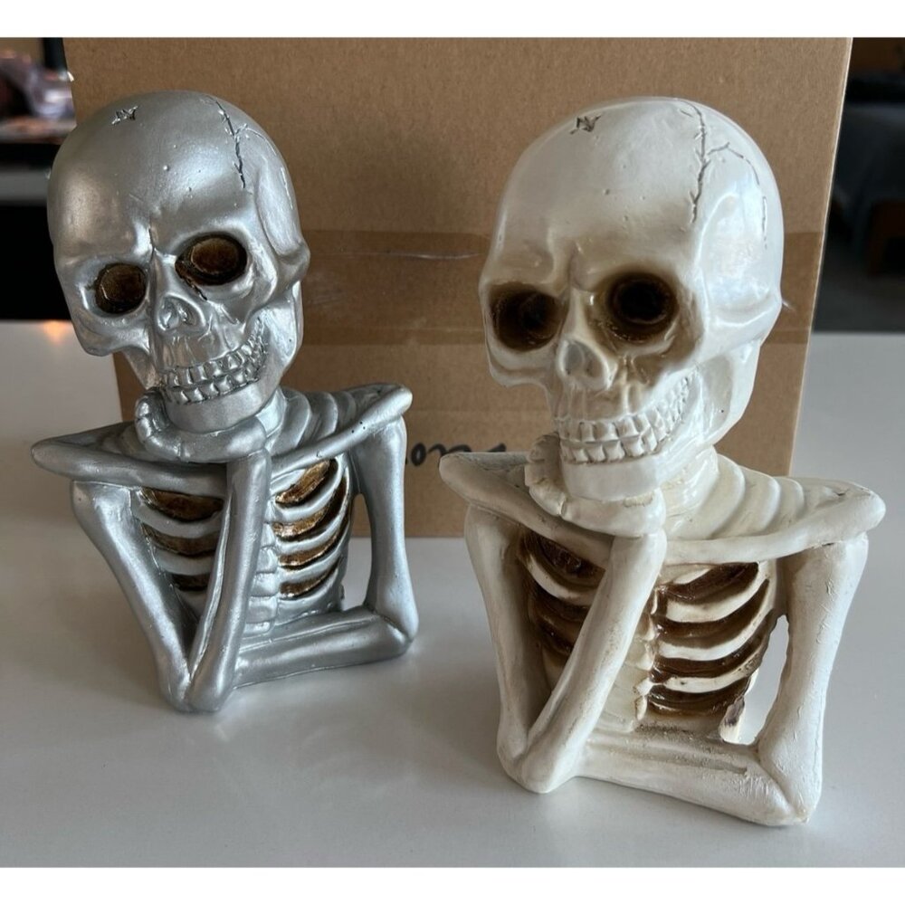 Halloween skeletal bust in a "thinking" pose, resting its skull in its hand.